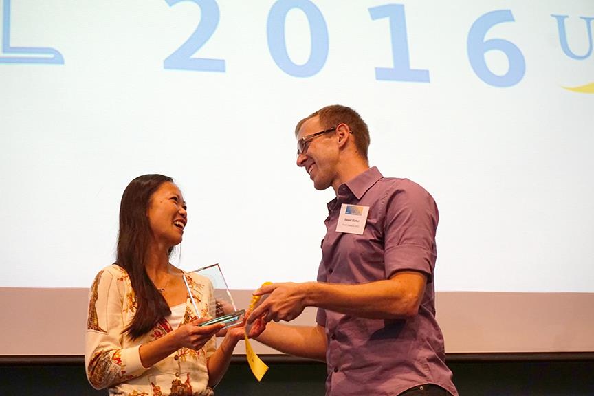Last year's UCSB Grad Slam Champion, Danny Hieber, presents the 2016 award to Nicole Leung. Credit: Patricia Marroquin